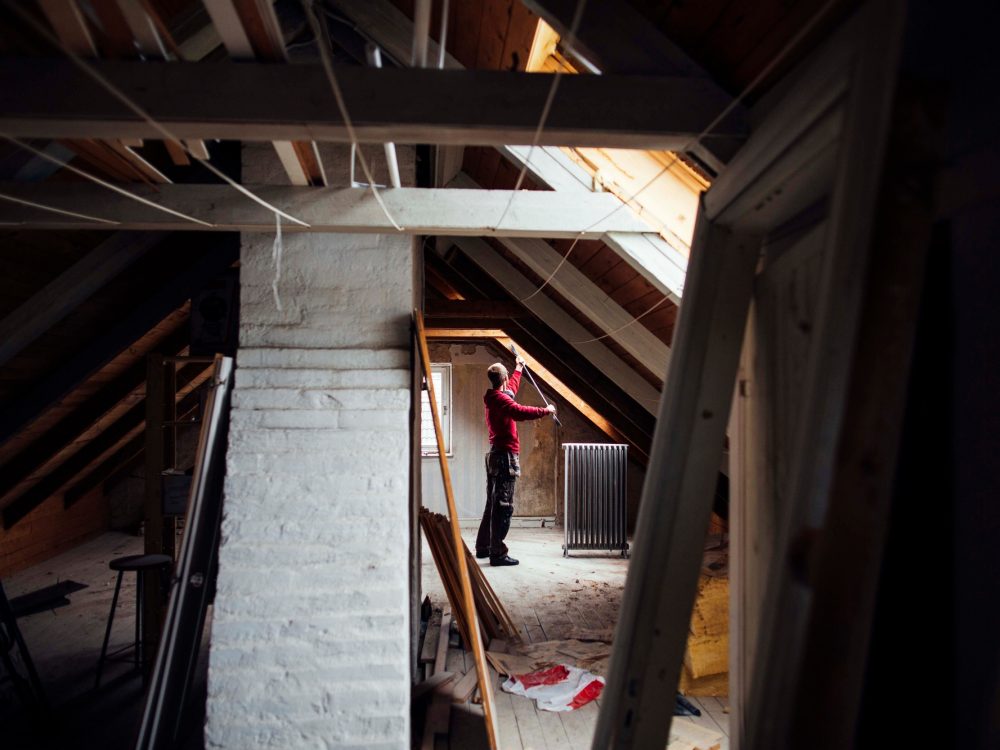 Person renovating an attic space Person renovating an attic space